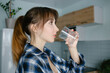 © Ann Marko - Portrait of young pretty girl drinking water from a glass at home. Introducing a good habit.