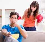 Fototapeta  - Wife unhappy that husband is watching boxing