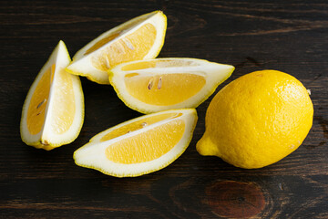 Wall Mural - Lemon Sliced Into Wedges: Two lemons, one whole and one that has been quartered