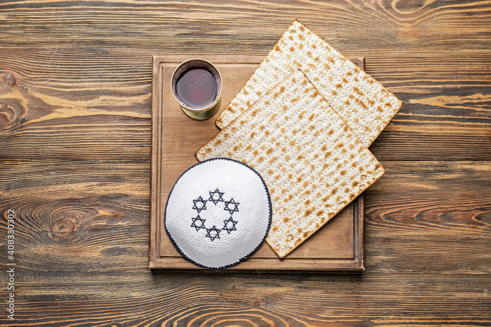 Composition with Jewish flatbread matza for Passover on wooden background