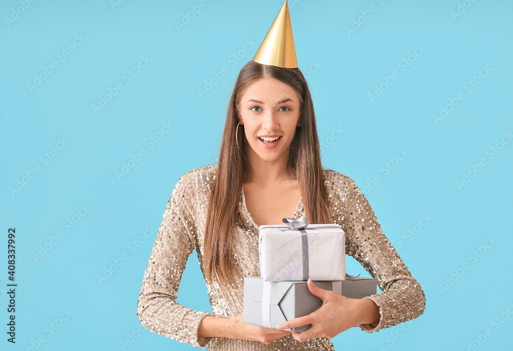 Young woman celebrating birthday on color background