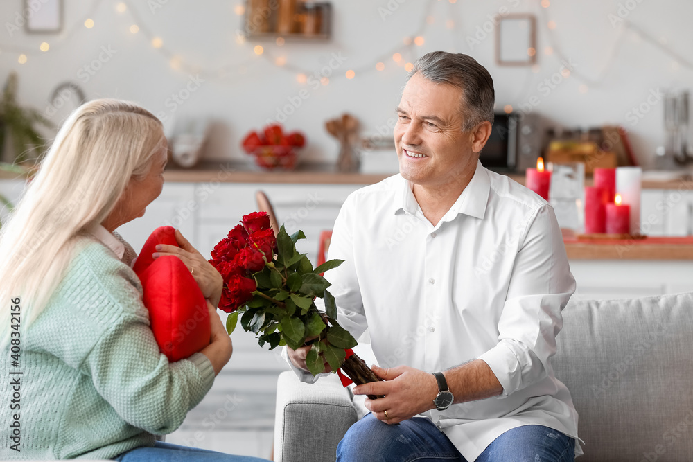 Mature couple celebrating Valentine's Day at home