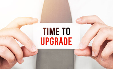 Poster - Businessman holding a card with text Time to upgrade ,business concept