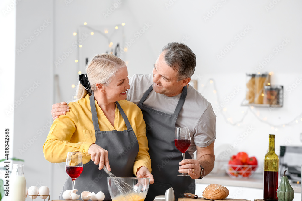 Mature couple celebrating Valentine's Day while cooking festive dinner