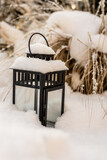 Fototapeta  - Latarenka w ogrodzie przykryta śniegiem na tle traw ozdobnych
