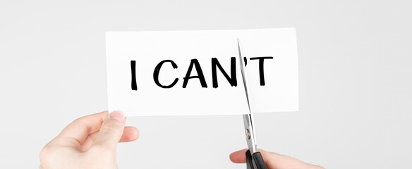 Poster - man using scissors to remove the word can't to read i can. concept for positive attitude and motivat