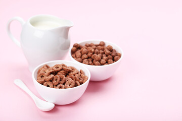 Poster - Chocolate corn flakes with milk in jar and spoon on pink background