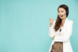Portrait of happy smiling asian woman customer support phone operator and pointing to empty copy space isolated on green background, Call center or Customer service concept