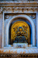 Poster - Vertical shot of an ancient temple with carvings and a Buddha statue