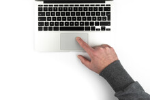 Overhead View Of Person Using Touchpad Or Trackpad On Laptop Computer On White Background