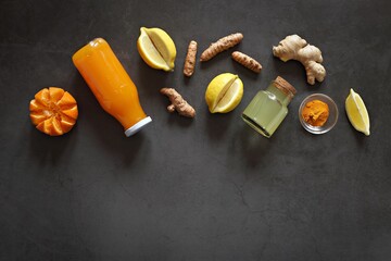 Wall Mural - Pure vegan Immunity system booster. Ginger shot with citrus fruits juice and turmeric. Flat layot, copy space