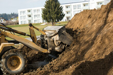 Loader Shovels In A Pile Of Dirt At A Construction Site Earth