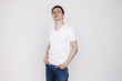 © Sotnikow - Portrait of smiling young man in a white t-shirt isolated on white background.