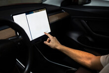 Technician programming on digital tablet in car at auto repair shop