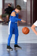 © Joe - Young athletic boy playing in a game of basketball