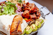 Mixed grill meat fried vegetables and grilled salmon fish fillets decoration in warm dish. Assorted delicious grilled kebab served with herbs on platter. Restaurant menu barbecue plate Bbq party meal