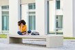 © Antonio Ovejero Diaz/Westend61 - Student writing in book while sitting on bench at university campus
