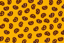 Pattern Of Chocolate Pretzels¬†against Yellow Background