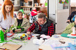 © DREAMSTOCK1982/Westend61 - Female nurse doing creative craft with disabled man and woman in nursing home