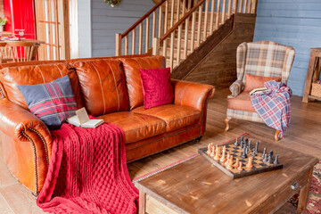 Wall Mural - cozy all wooden interior of a country house in a wooden design. spacious living room with kitchen area with large windows. bedroom on the second floor.