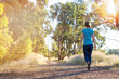 © Caro Telfer/Austockphoto - Young woman walking away on bush trail