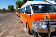 © Caro Telfer/Austockphoto - Orange school buses lined up outside a country school