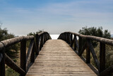 Fototapeta Pomosty - long wooden boardwalk and beach access leads to beach and glistening ocean