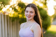 © Clare Seibel-Barnes/Austockphoto - Close up portrait of a fourteen year old brunette girl with bokeh light in the background