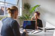 © Jodie Johnson/Austockphoto - Young professional girl on the phone working opposite a colleague