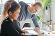 © Jodie Johnson/Austockphoto - Female worker explaining something to a male team member