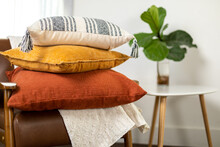 Stacked Colorful Fall Pillows On Chair