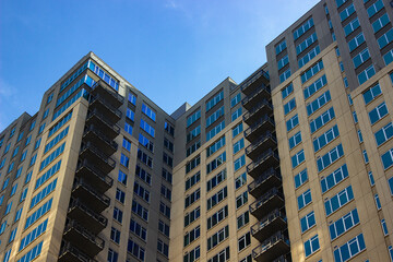 Wall Mural - modern apartment complex, Urban design, Shadow casting over a modern high rise in the city