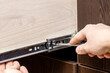 furniture cabinets repair or adjusting. person fixing kitchen cabinet drawer slides