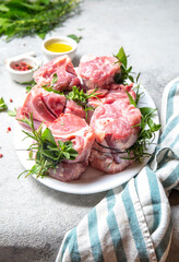 Wall Mural - Pork Osso Buco, shin Pork shanks with fresh aromatic herbs on white marmol board