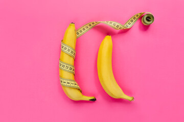 Yellow banana with measurement tape on pink background. Men penis size concept. Flat lay, top view, copy space.