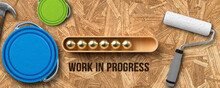 Stylized Loading Bar With Message WORK IN PROGRESS And Painting Tools On Wooden Background