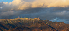 Telephoto Image Taken From Pasadena, California Of Snow Dusted Mount Wilson In Late Afternoon. Mount Wilson Is On The San Gabriel Mountains. Various Types Of Antennas Are Visible On The Ridge Top.