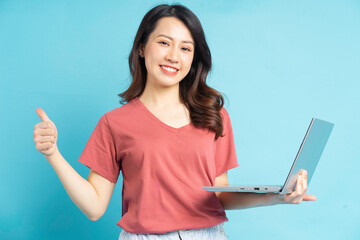 Wall Mural - beautiful asian woman using laptop to video call with friends