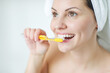 © nuzza11 - Portrait of a beautiful woman brushing her teeth in the bathroom. High quality photo