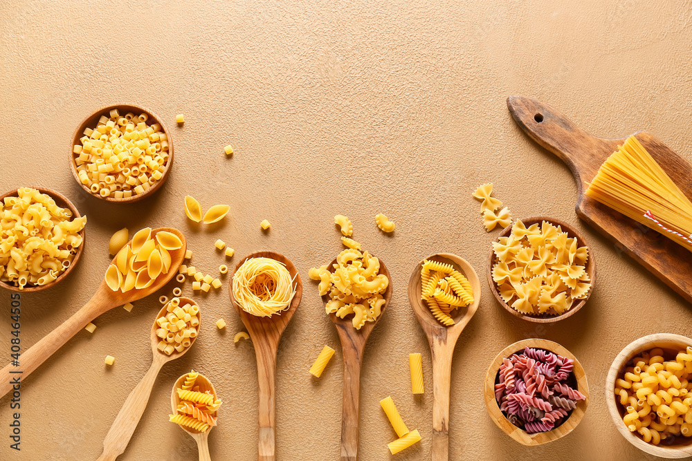 Assortment of dry pasta on color background