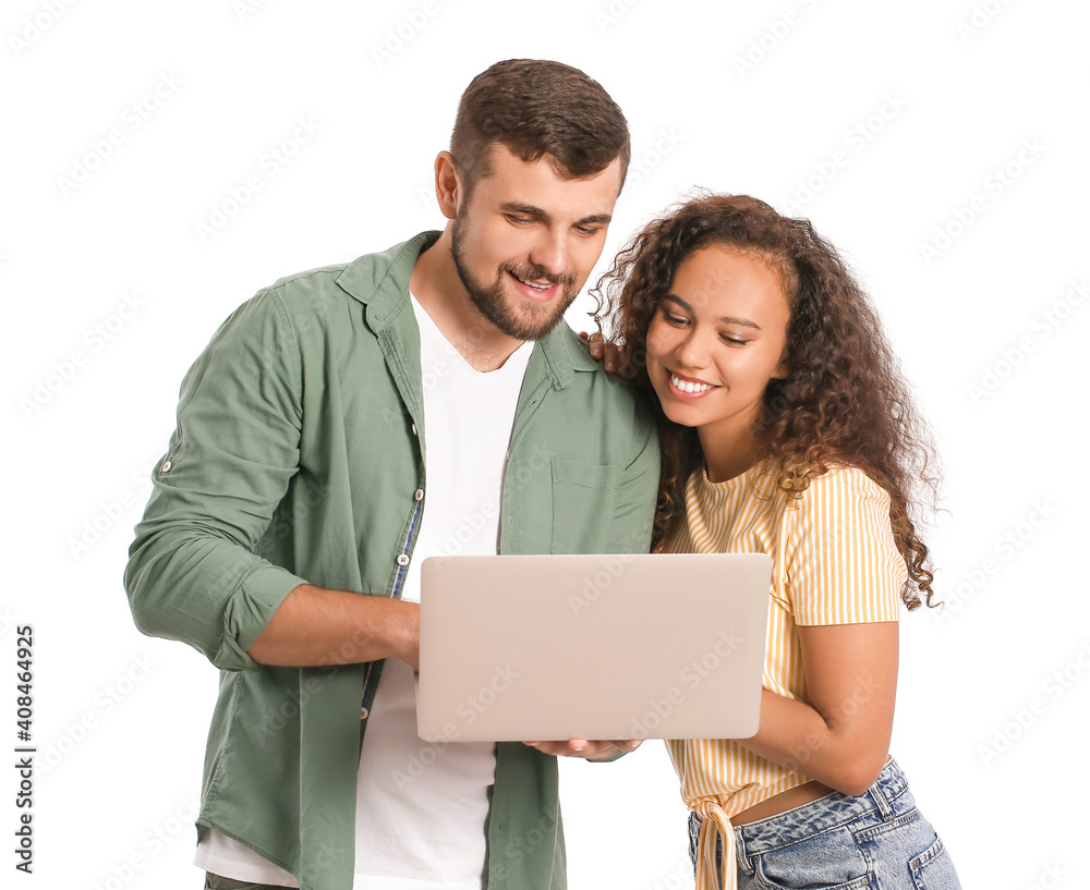 Young couple with laptop on white background