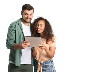 Young couple with tablet computer on white background