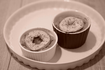 Sticker - Selective focus shot of delicious homemade apple and rice pudding in baking molds in low contrast