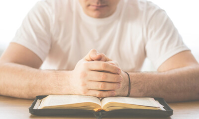 Wall Mural - Reading the bible. Prayer. Hands folded in prayer concept. The concept of faith, spirituality and religion