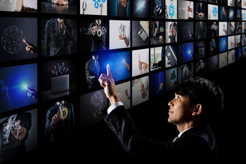 Wall Mural - Asian businessman editing a lot of images