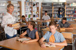 © JackF - Teenage boys and girls preparing for exam in school library