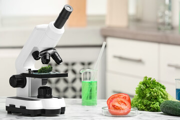 Wall Mural - microscope and fresh vegetables on table in laboratory, space for text. poison detection