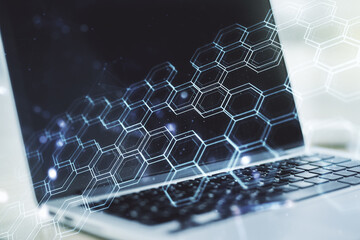 Poster - Double exposure of technology hologram with hexagon on laptop background. Research and development software concept