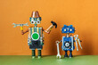 Robots service workers. Fixing maintenance robotics electronic diagnostics concept. Funny repairman toys holds work tools: pliers, hand wrench, hammer. Brown green background.