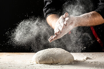 Photo of flour and men hands with flour splash. Cooking bread. Kneading the Dough. Isolated on dark background. Empty space for text